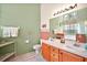 Bathroom featuring double sinks, vanity, decorative elements, and a neutral color scheme at 25129 Riverwalk Dr, Leesburg, FL 34748