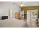 Bright bedroom featuring wood floors, a ceiling fan, and access to the lanai at 25129 Riverwalk Dr, Leesburg, FL 34748
