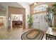 Inviting foyer showcasing a vaulted ceiling, decorative lighting, and views of an adjacent office space at 25129 Riverwalk Dr, Leesburg, FL 34748