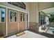 Welcoming front entrance featuring a decorative door with sidelights and wreaths, plus a cozy seating area on the porch at 25129 Riverwalk Dr, Leesburg, FL 34748