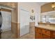 Hallway featuring a closet, neutral paint, and tile flooring, seamlessly connecting to other living spaces at 25129 Riverwalk Dr, Leesburg, FL 34748