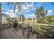 Screened-in patio featuring a barbecue grill and overlooking the verdant golf course at 25129 Riverwalk Dr, Leesburg, FL 34748