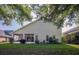 Wide shot of the backyard showcasing the exterior of the home and screened in porch at 2539 Caithness Way, Clermont, FL 34714