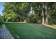 Lush green backyard with mature trees, perfect for outdoor activities and relaxation at 2539 Caithness Way, Clermont, FL 34714