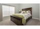Charming bedroom with carpeted floors, a dark-wood bed frame, and bright natural light at 2539 Caithness Way, Clermont, FL 34714