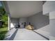 View of the carport with a golf cart and a car covered, offering ample parking and storage space at 2539 Caithness Way, Clermont, FL 34714