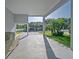 View of a spacious carport leading to a well-maintained lawn with neatly trimmed trees, offering ample parking at 2539 Caithness Way, Clermont, FL 34714