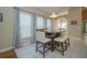 Dining area featuring counter-height table and chairs, view of the window with patterned curtains at 2539 Caithness Way, Clermont, FL 34714