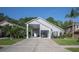 Charming home featuring an attached carport, well-manicured lawn, and inviting landscaping for curb appeal at 2539 Caithness Way, Clermont, FL 34714