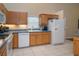 Bright kitchen featuring light wood cabinetry, stainless steel appliances, and white tiled floors at 2539 Caithness Way, Clermont, FL 34714