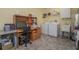 Well-equipped laundry room features a desk, storage, utility sink, washer, and dryer at 2539 Caithness Way, Clermont, FL 34714