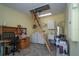 Bright laundry room with washer, dryer, utility sink, water heater, desk, and attic access at 2539 Caithness Way, Clermont, FL 34714