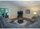 Spacious living room featuring a large gray sectional sofa and hardwood flooring at 2539 Caithness Way, Clermont, FL 34714