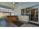Enclosed patio with ceiling fan and lights featuring a hot tub and covered lounge seating area at 2539 Caithness Way, Clermont, FL 34714