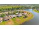 A waterfront home in a peaceful community surrounded by lush greenery and a serene lake at 2641 Meadow View Ct, Kissimmee, FL 34746