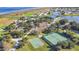 Aerial view of community amenities including tennis court, basketball court, community buildings and access to the lake at 2641 Meadow View Ct, Kissimmee, FL 34746