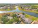 Beautiful aerial view of a waterfront community featuring well-maintained homes and lush landscaping near a lake at 2641 Meadow View Ct, Kissimmee, FL 34746