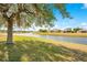 Picturesque backyard view showcasing a serene pond, lush greenery, and well-kept lawn at 2641 Meadow View Ct, Kissimmee, FL 34746