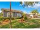 Single-story home featuring manicured landscaping, a tiled roof and paved driveway at 2641 Meadow View Ct, Kissimmee, FL 34746