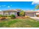 Charming single-story home with well-manicured lawn and tiled roof under blue skies at 2641 Meadow View Ct, Kissimmee, FL 34746