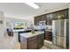 Well-lit kitchen with stainless steel appliances, an island, and dark cabinetry at 2641 Meadow View Ct, Kissimmee, FL 34746
