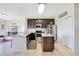 Well-equipped kitchen with stainless steel appliances, granite countertops and dark wood cabinets at 2641 Meadow View Ct, Kissimmee, FL 34746