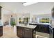 Spacious kitchen featuring dark wood cabinetry, stainless appliances and an island with countertop at 2641 Meadow View Ct, Kissimmee, FL 34746