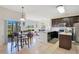 Open kitchen featuring stainless steel appliances, island, and adjacent breakfast nook at 2641 Meadow View Ct, Kissimmee, FL 34746