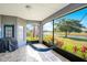 Relaxing screened lanai with a hammock and a view of the water at 2641 Meadow View Ct, Kissimmee, FL 34746
