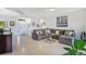 Bright and airy living room with tile floors and large sectional sofa at 2641 Meadow View Ct, Kissimmee, FL 34746