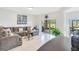 Open living room with large sectional sofa, tile flooring, and sliding glass doors to a patio at 2641 Meadow View Ct, Kissimmee, FL 34746