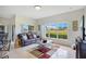 Bright living room featuring a large window with views of the outdoors and comfortable seating at 2641 Meadow View Ct, Kissimmee, FL 34746