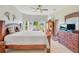 Spacious main bedroom with ceiling fan, tile floors, and large windows overlooking backyard at 2641 Meadow View Ct, Kissimmee, FL 34746