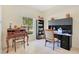 Well-lit home office with desk, bookshelves, and large window at 2641 Meadow View Ct, Kissimmee, FL 34746