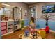Bright playroom with kid-friendly furniture, toys, and a colorful tree wall decal at 2641 Meadow View Ct, Kissimmee, FL 34746