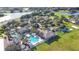 Aerial view of the community pool and clubhouse surrounded by palm trees and green space near a lake at 2641 Meadow View Ct, Kissimmee, FL 34746
