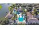 Aerial view of community pool, surrounded by palm trees, lounge chairs, and well-maintained landscaping at 2641 Meadow View Ct, Kissimmee, FL 34746