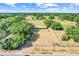 Wide aerial shot showcasing a property with extensive land, lush greenery, and a home with a vibrant green roof at 274 W Kings Hwy, Center Hill, FL 33514