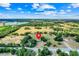 Expansive aerial view highlighting the property's vast land and scenic location with a lake in the distance at 274 W Kings Hwy, Center Hill, FL 33514