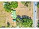 Overhead view of a property with lush green landscape, a clear pool, a quaint red house, and ample space at 274 W Kings Hwy, Center Hill, FL 33514