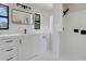 Bright bathroom featuring a black framed mirror, black hardware, and a tiled shower at 274 W Kings Hwy, Center Hill, FL 33514