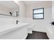 Updated bathroom features sleek black hardware, white tiling, and a modern design at 274 W Kings Hwy, Center Hill, FL 33514