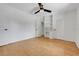 Bedroom featuring wood floors, a ceiling fan, built-in shelving, and ample closet space at 274 W Kings Hwy, Center Hill, FL 33514