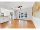 Bright dining room boasts hardwood floors, ceiling fan, and access to the screened porch and an adjacent modern kitchen at 274 W Kings Hwy, Center Hill, FL 33514