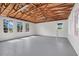 Spacious garage with exposed ceiling, natural light from windows, and durable concrete flooring, perfect for versatile use at 274 W Kings Hwy, Center Hill, FL 33514