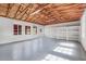 Expansive garage featuring bright lighting, shelving, and painted walls with abundant natural light and durable concrete flooring at 274 W Kings Hwy, Center Hill, FL 33514