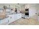 Modern kitchen features granite countertops, stainless steel appliances, and updated white cabinets at 274 W Kings Hwy, Center Hill, FL 33514