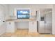 Eat-in kitchen with granite counters, white cabinetry, stainless fridge, and view to backyard at 274 W Kings Hwy, Center Hill, FL 33514