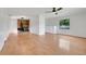 Bright living room features hardwood flooring, a stone fireplace, and a large window at 274 W Kings Hwy, Center Hill, FL 33514