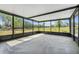 Enclosed patio offers serene views of the property's green landscape, perfect for relaxing and enjoying the outdoors at 274 W Kings Hwy, Center Hill, FL 33514